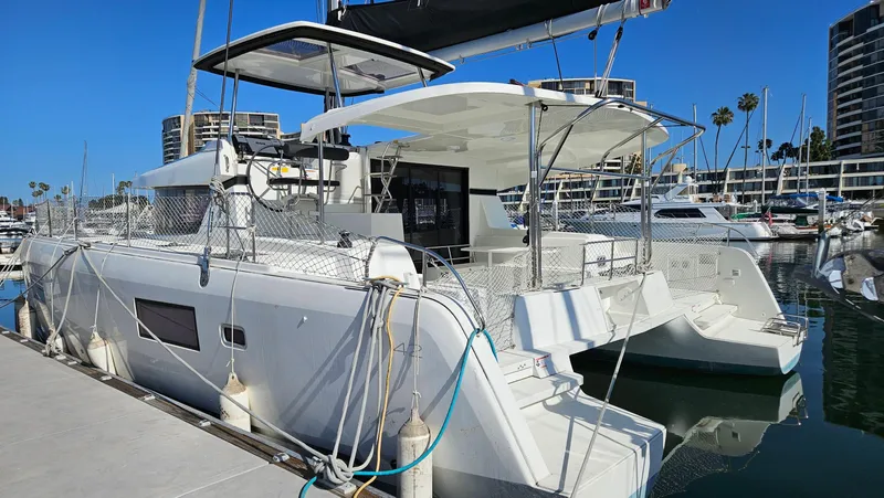 Ariella Yacht Photos Pics 2021 Lagoon 42 catamaran docked at marina, featuring modern design and spacious deck.