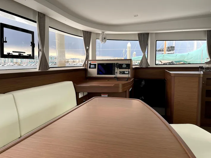 Ariella Yacht Photos Pics Interior of 2021 Lagoon 42 catamaran with modern wood finish and panoramic windows.