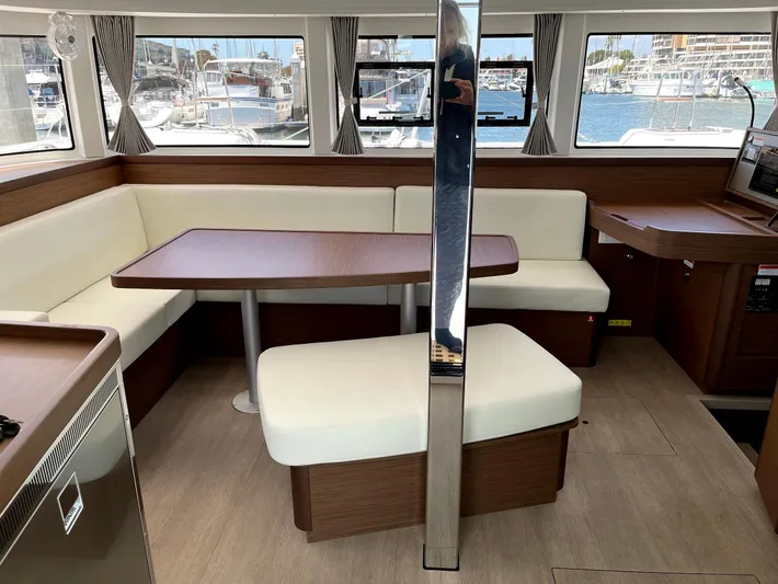 Ariella Yacht Photos Pics Interior of 2021 Lagoon 42 catamaran with dining area and marina view.