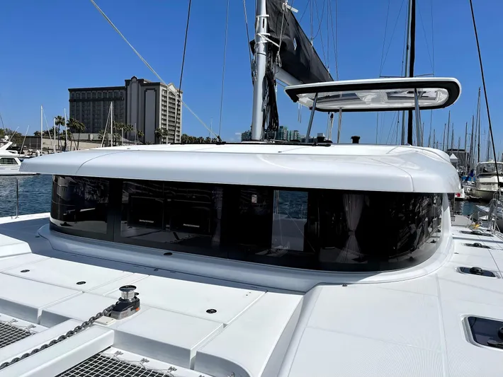Ariella Yacht Photos Pics 2021 Lagoon 42 catamaran docked at marina with clear blue sky.