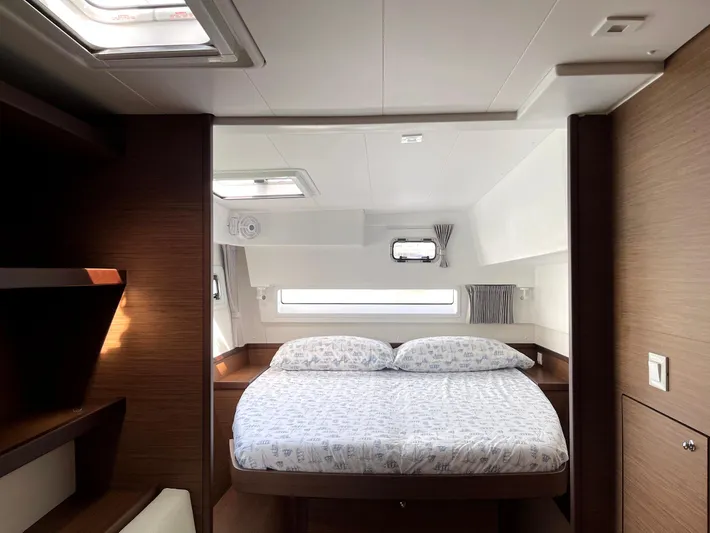 Ariella Yacht Photos Pics Luxurious cabin interior of 2021 Lagoon 42 catamaran with cozy bed and modern design.