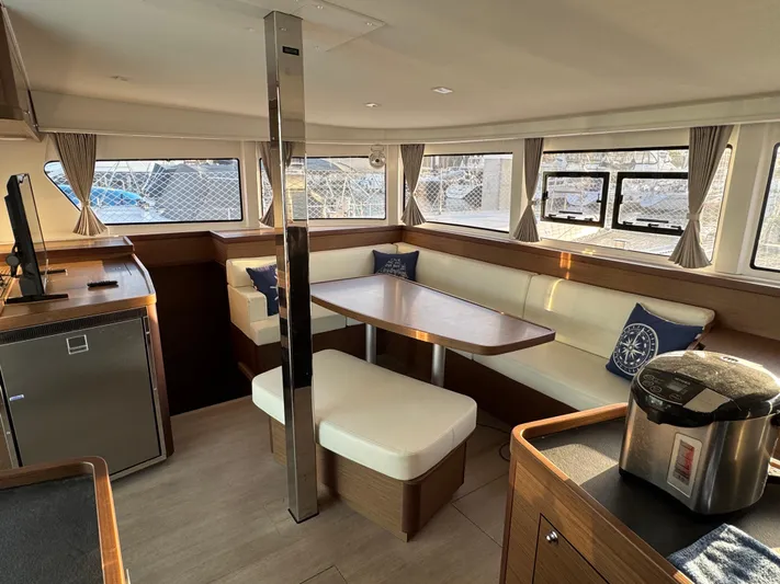 Ariella Yacht Photos Pics Interior of 2021 Lagoon 42 catamaran with modern seating and dining area.
