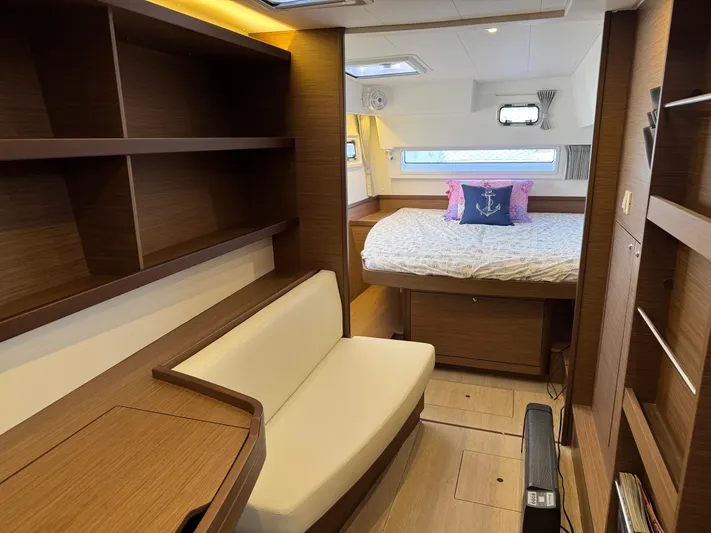 Ariella Yacht Photos Pics Interior of 2021 Lagoon 42 catamaran with cozy bedroom and wooden furnishings.