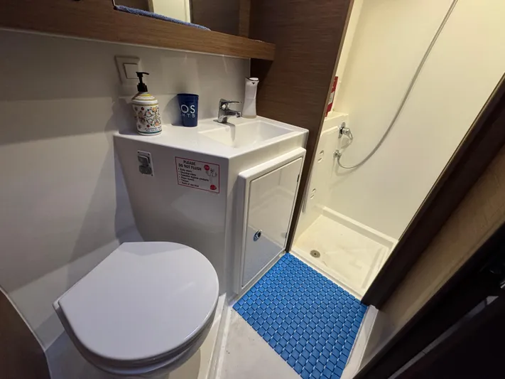 Ariella Yacht Photos Pics Bathroom interior of 2021 Lagoon 42 yacht with shower, sink, and toilet.