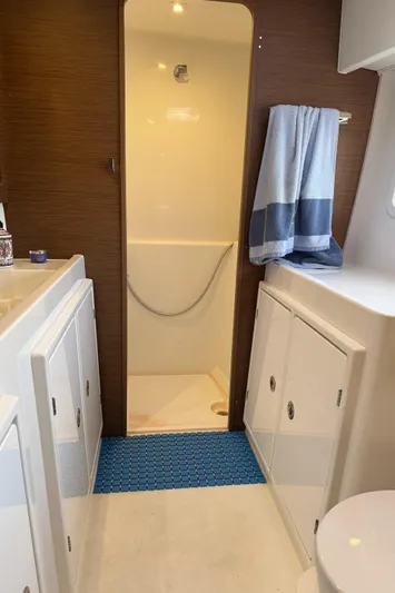 Ariella Yacht Photos Pics Interior of 2021 Lagoon 42 yacht bathroom with shower and storage cabinets.