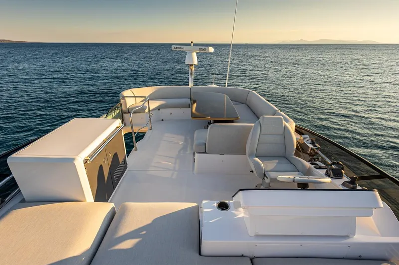 Mask Yacht Photos Pics Luxurious 2023 Azimut 53 yacht deck with elegant seating, overlooking serene ocean waters.