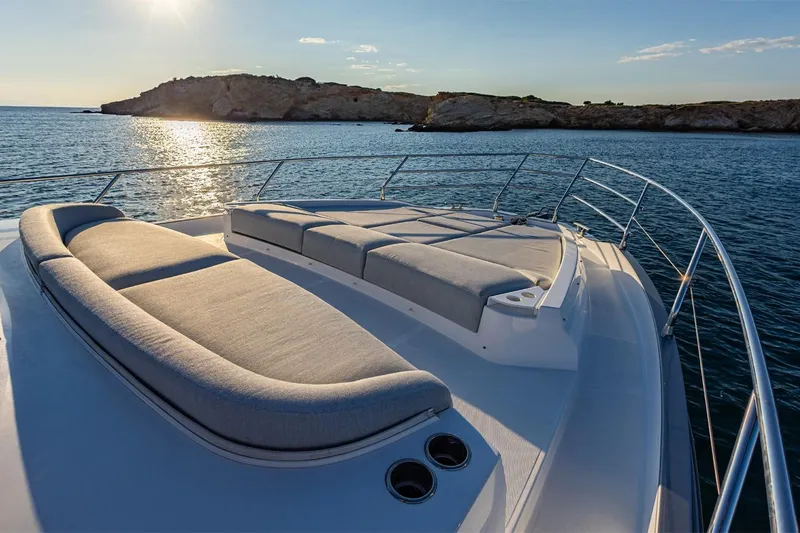 Mask Yacht Photos Pics Luxurious 2023 Azimut 53 yacht deck with sun loungers, ocean view, and sunset backdrop.