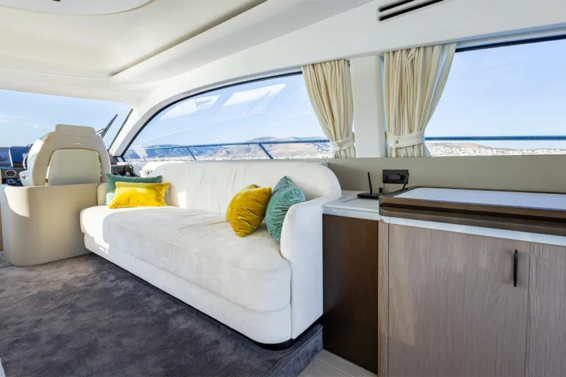Mask Yacht Photos Pics Luxurious interior of 2023 Azimut 53 yacht with plush seating and scenic ocean view.