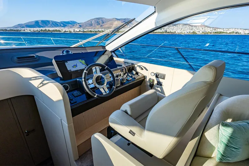 Mask Yacht Photos Pics Luxurious 2023 Azimut 53 yacht interior with modern helm and scenic ocean view.