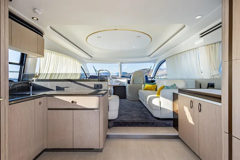 Mask Yacht Photos Pics Luxurious interior of 2023 Azimut 53 yacht with modern kitchen and elegant seating area.