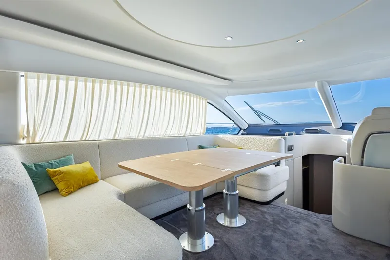 Mask Yacht Photos Pics Luxurious interior of 2023 Azimut 53 yacht with elegant seating and ocean view.