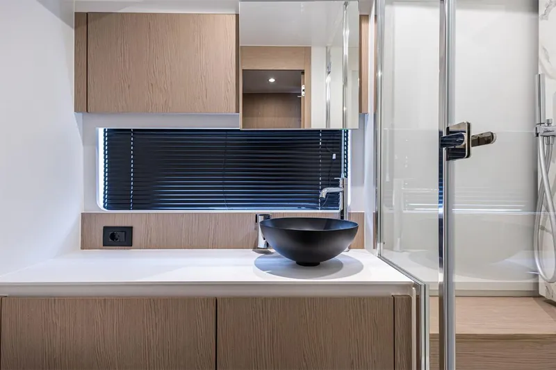 Mask Yacht Photos Pics Modern bathroom interior of 2023 Azimut 53 yacht with sleek design and black basin.