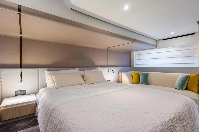 Mask Yacht Photos Pics Luxurious bedroom interior of 2023 Azimut 53 yacht with modern design and cozy bedding.