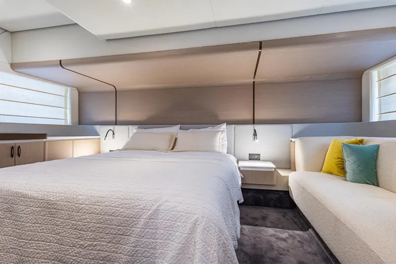 Mask Yacht Photos Pics Luxurious bedroom interior of 2023 Azimut 53 yacht with modern design and cozy bedding.