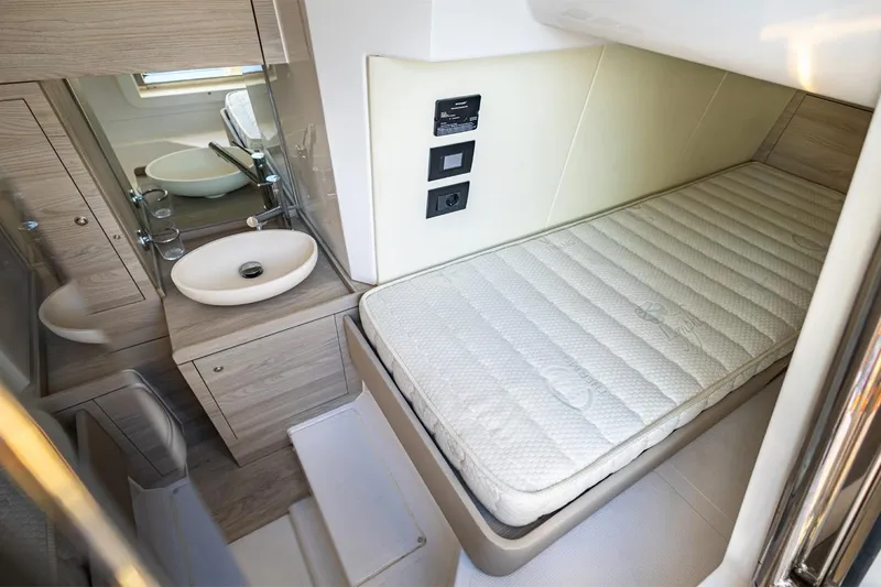 Mask Yacht Photos Pics 2023 Azimut 53 yacht interior with compact bed and modern bathroom.