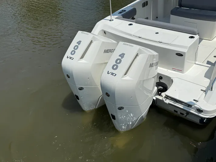  Yacht Photos Pics 2024 Boston Whaler 330 Outrage with twin Mercury 400 V10 engines in water.