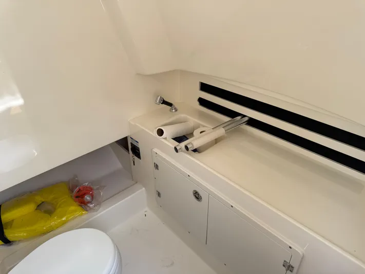  Yacht Photos Pics 2024 Boston Whaler 330 Outrage interior with sink, storage, and life jacket.