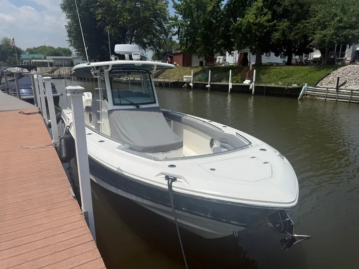  Yacht Photos Pics 2024 Boston Whaler 330 Outrage docked on a sunny day.