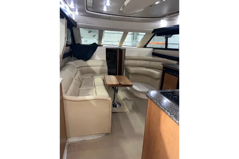  Yacht Photos Pics Interior of 2004 Meridian 341 Sedan yacht with beige seating and wooden accents.