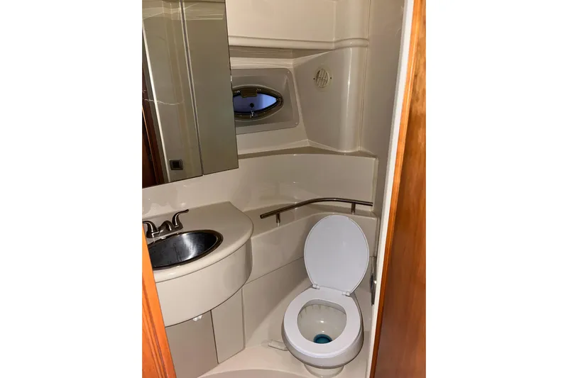  Yacht Photos Pics Bathroom interior of a 2004 Meridian 341 Sedan yacht, featuring a sink and toilet.