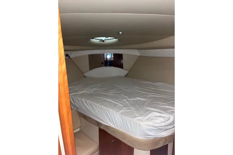  Yacht Photos Pics Interior cabin of 2004 Meridian 341 Sedan yacht with bed and porthole.