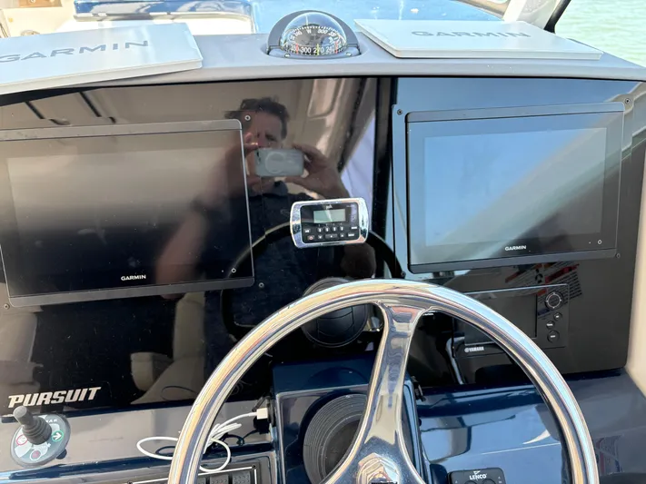  Yacht Photos Pics Control panel of 2017 Pursuit DC 325 Dual Console with Garmin displays and steering wheel.