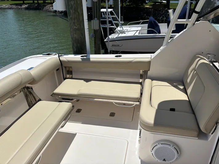  Yacht Photos Pics 2017 Pursuit DC 325 Dual Console boat interior with beige seating and speaker.