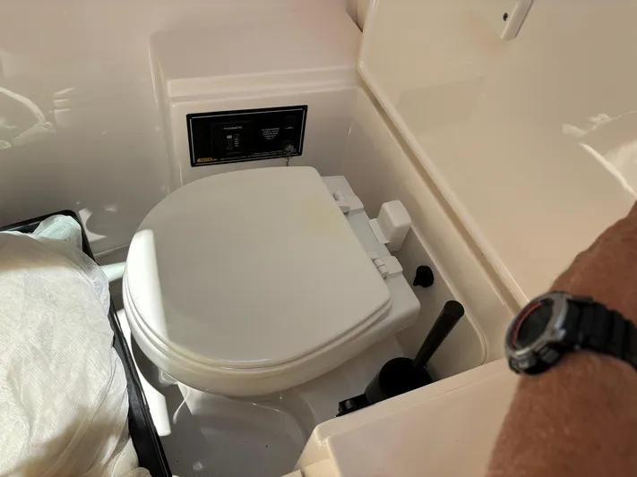  Yacht Photos Pics 2017 Pursuit DC 325 Dual Console boat toilet interior, featuring a compact marine design.