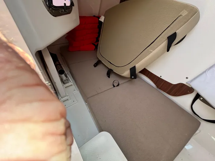  Yacht Photos Pics Interior cabin of a 2017 Pursuit DC 325 Dual Console boat with cushions and life jackets.