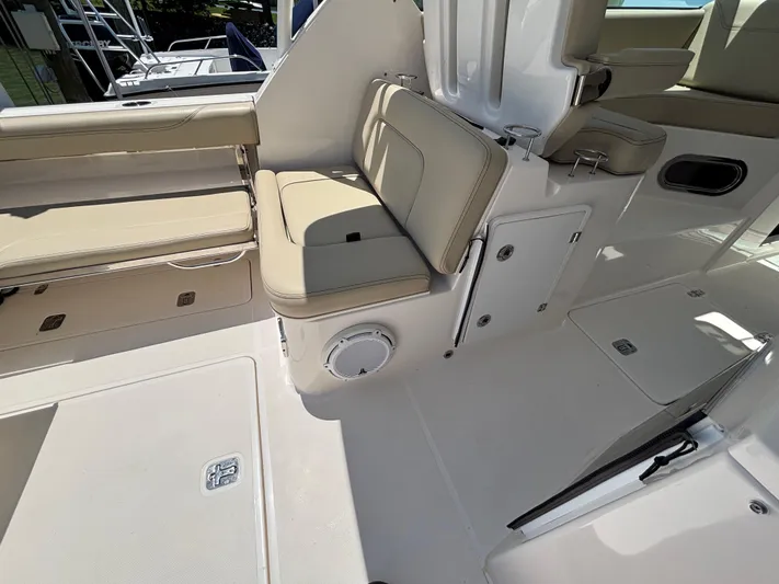  Yacht Photos Pics 2017 Pursuit DC 325 Dual Console interior with beige seating and storage compartments.