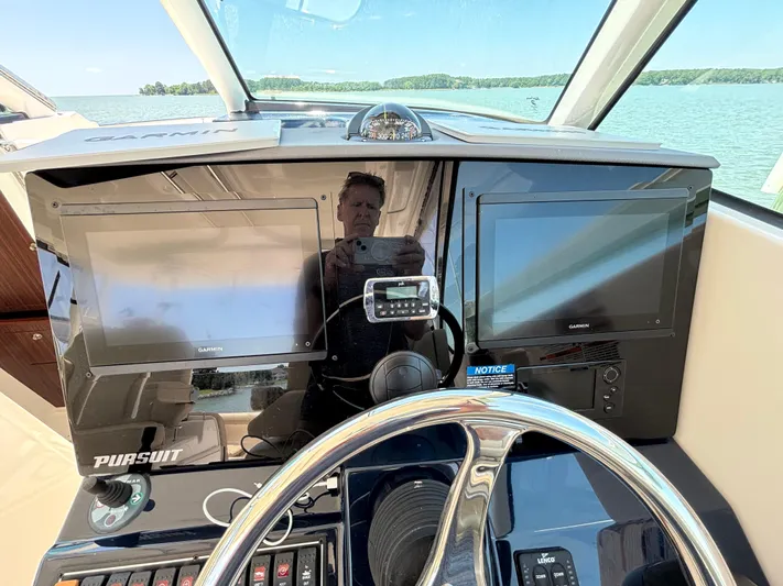  Yacht Photos Pics 2017 Pursuit DC 325 Dual Console dashboard with Garmin displays and steering wheel.