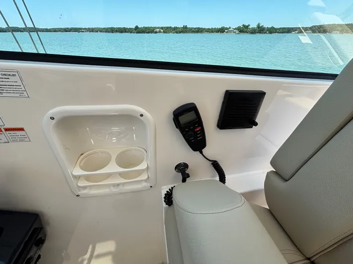 Yacht Photos Pics Interior of 2017 Pursuit DC 325 boat with cup holders and communication device.