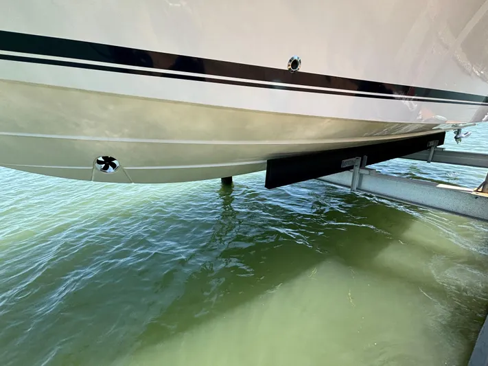  Yacht Photos Pics 2017 Pursuit DC 325 Dual Console boat hull above water on a lift.