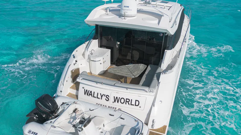 Wallys World Yacht Photos Pics 2017 Sea Ray L590 yacht named "Wally's World" cruising in clear turquoise waters.