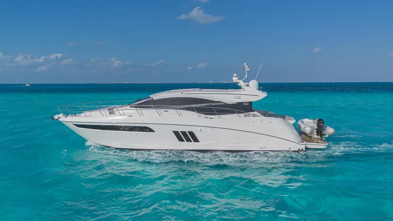 Wallys World Yacht Photos Pics 2017 Sea Ray L590 yacht cruising on clear turquoise waters under a blue sky.