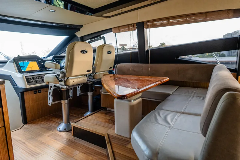 Wallys World Yacht Photos Pics Luxurious interior of 2017 Sea Ray L590 yacht with helm and seating area.