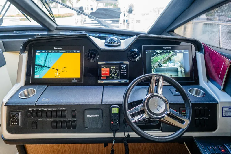 Wallys World Yacht Photos Pics 2017 Sea Ray L590 helm with dual navigation screens and modern steering wheel.