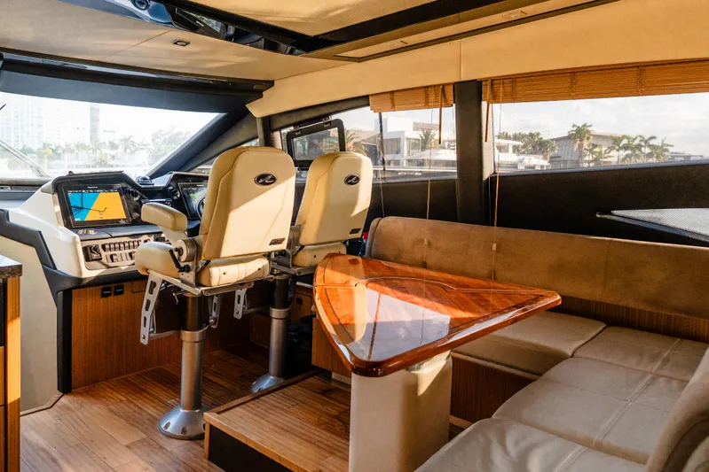 Wallys World Yacht Photos Pics Luxurious interior of 2017 Sea Ray L590 yacht with helm and seating area.