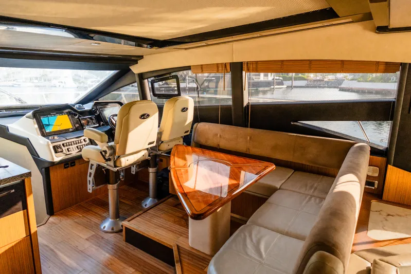 Wallys World Yacht Photos Pics Luxurious 2017 Sea Ray L590 yacht interior with helm, seating, and wooden table.