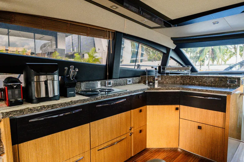 Wallys World Yacht Photos Pics Luxurious 2017 Sea Ray L590 yacht kitchen with modern appliances and sleek wood cabinetry.