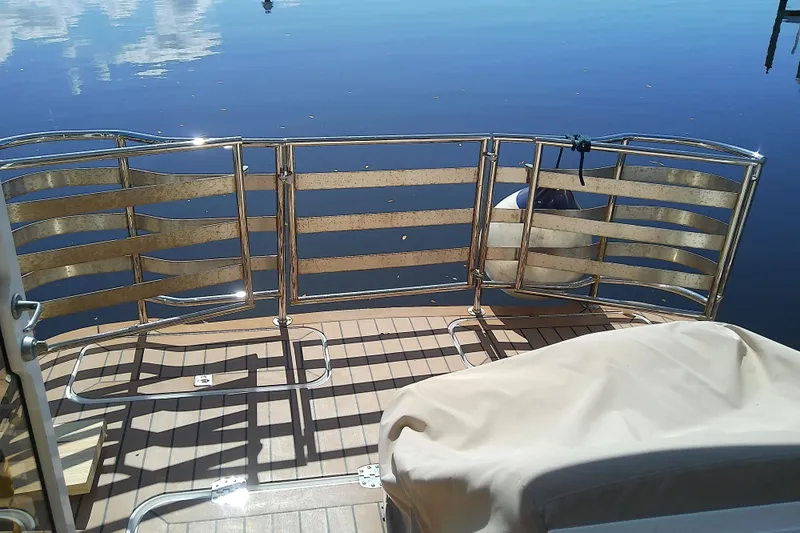  Yacht Photos Pics 2019 Floe Craft 3950C Aquafina boat deck with metal railing and calm water reflection.
