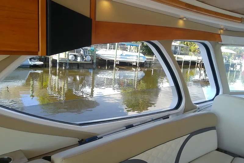 Yacht Photos Pics Interior view of 2019 Floe Craft 3950C Aquafina boat with large windows overlooking water.