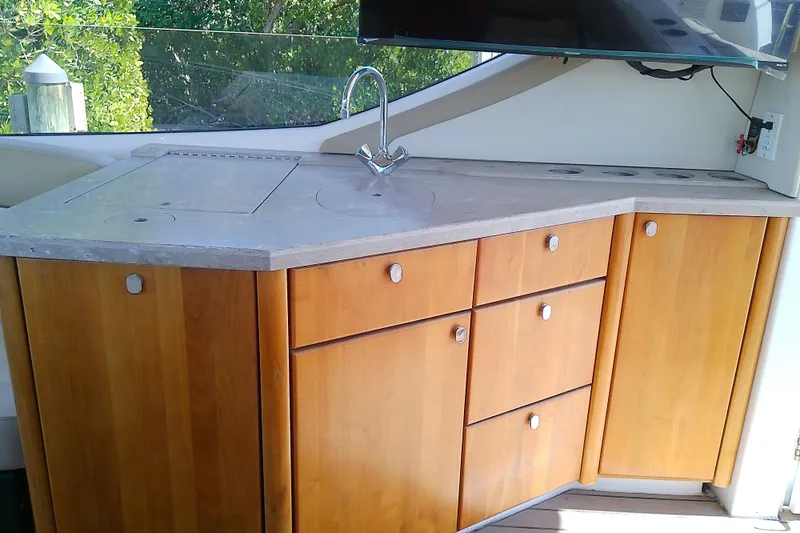  Yacht Photos Pics 2019 Floe Craft 3950C Aquafina boat kitchen with wooden cabinets and countertop.