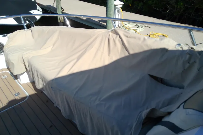  Yacht Photos Pics 2019 Floe Craft 3950C Aquafina boat covered with beige tarp on deck.