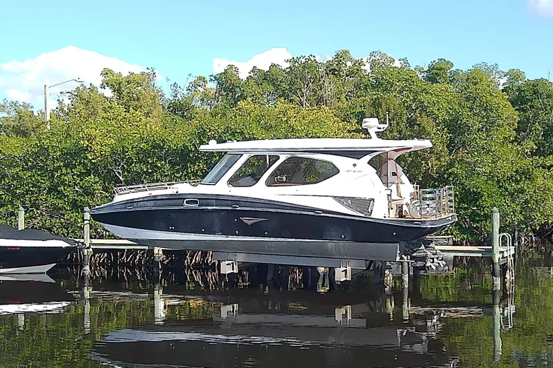  Yacht Photos Pics 2019 Floe Craft 3950C Aquafina boat docked near lush greenery.