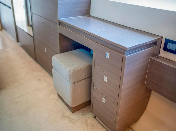 Breathe Yacht Photos Pics Modern wooden desk with drawers and cushioned stool on Leopard 53 Powercat, 2020 model.