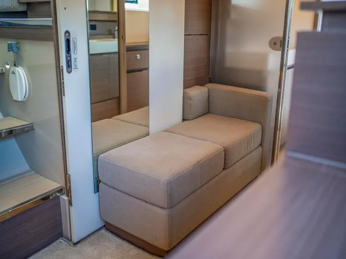 Breathe Yacht Photos Pics Interior of 2020 Leopard 53 Powercat, featuring a compact beige sofa and modern design elements.