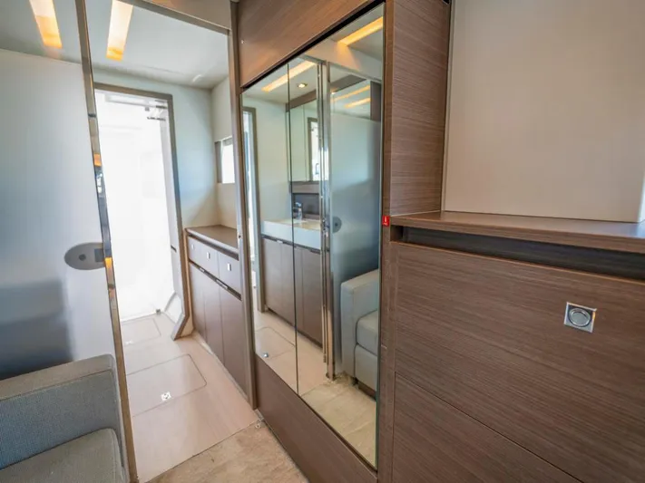 Breathe Yacht Photos Pics Interior of 2020 Leopard 53 Powercat yacht with modern wood finishes and mirrored cabinets.