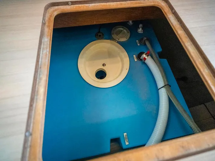 Breathe Yacht Photos Pics Interior view of a 2020 Leopard 53 Powercat's storage compartment with blue tank and hoses.