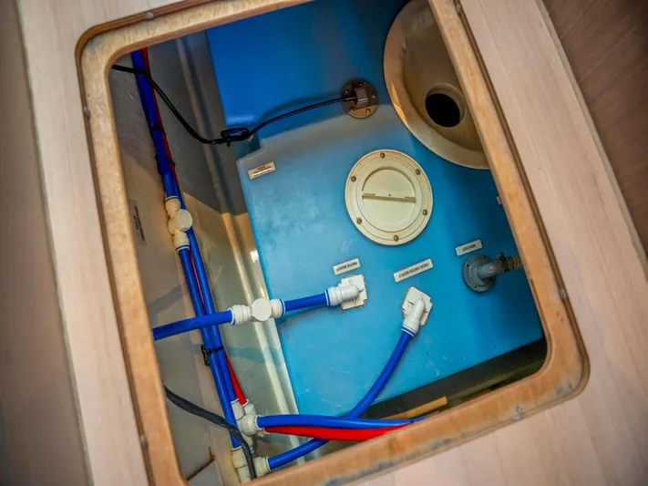 Breathe Yacht Photos Pics Engine compartment of 2020 Leopard 53 Powercat, showcasing blue and red piping system.